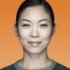 A face portrait of a woman smiling against an orange background | Contract Recruitment